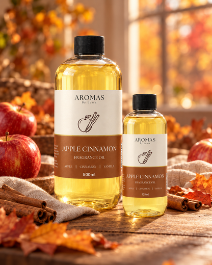Apple Cinnamon fragrance oil in 500 ml and 125 ml bottles styled with apples, cinnamon sticks and autumn leaves